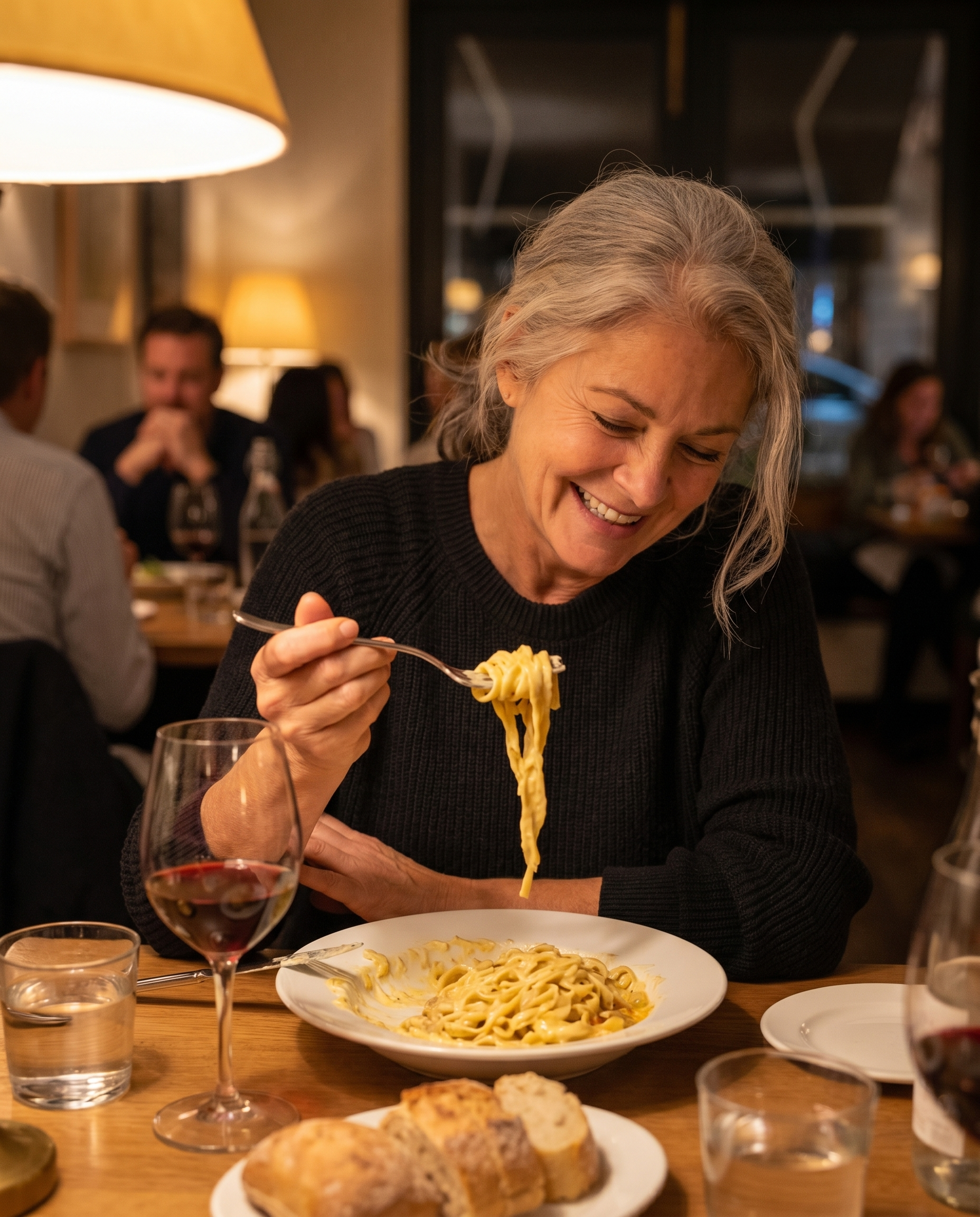 A woman eating a full meal at home, relaxed.